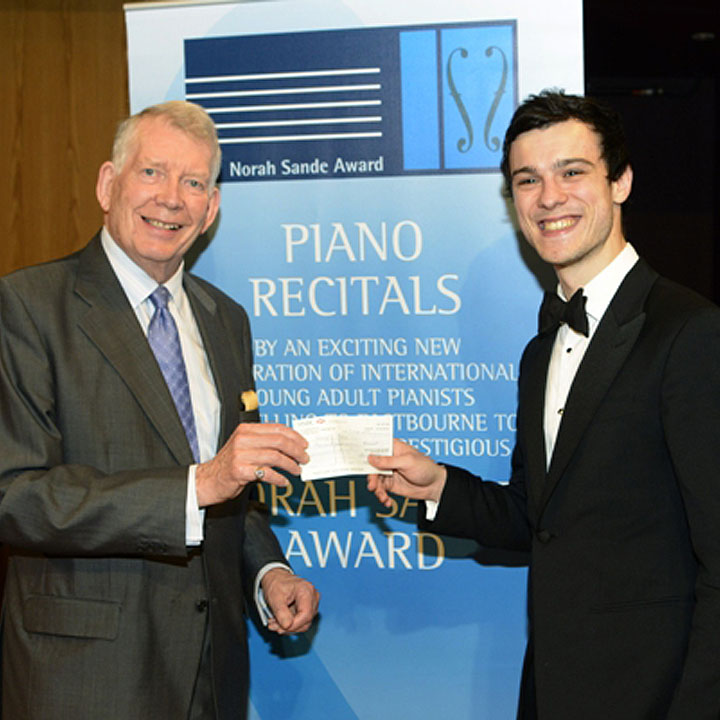 George Todica receives a cheque for £2,000 and an opportunity to perform in a recital from the Chairman of Adjudicators, David Patrick