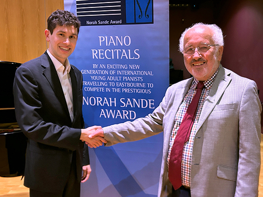 Jamie Cochrane, Winner of the 2024 Norah Sande recieves prize cheque from Richard DeeringAward